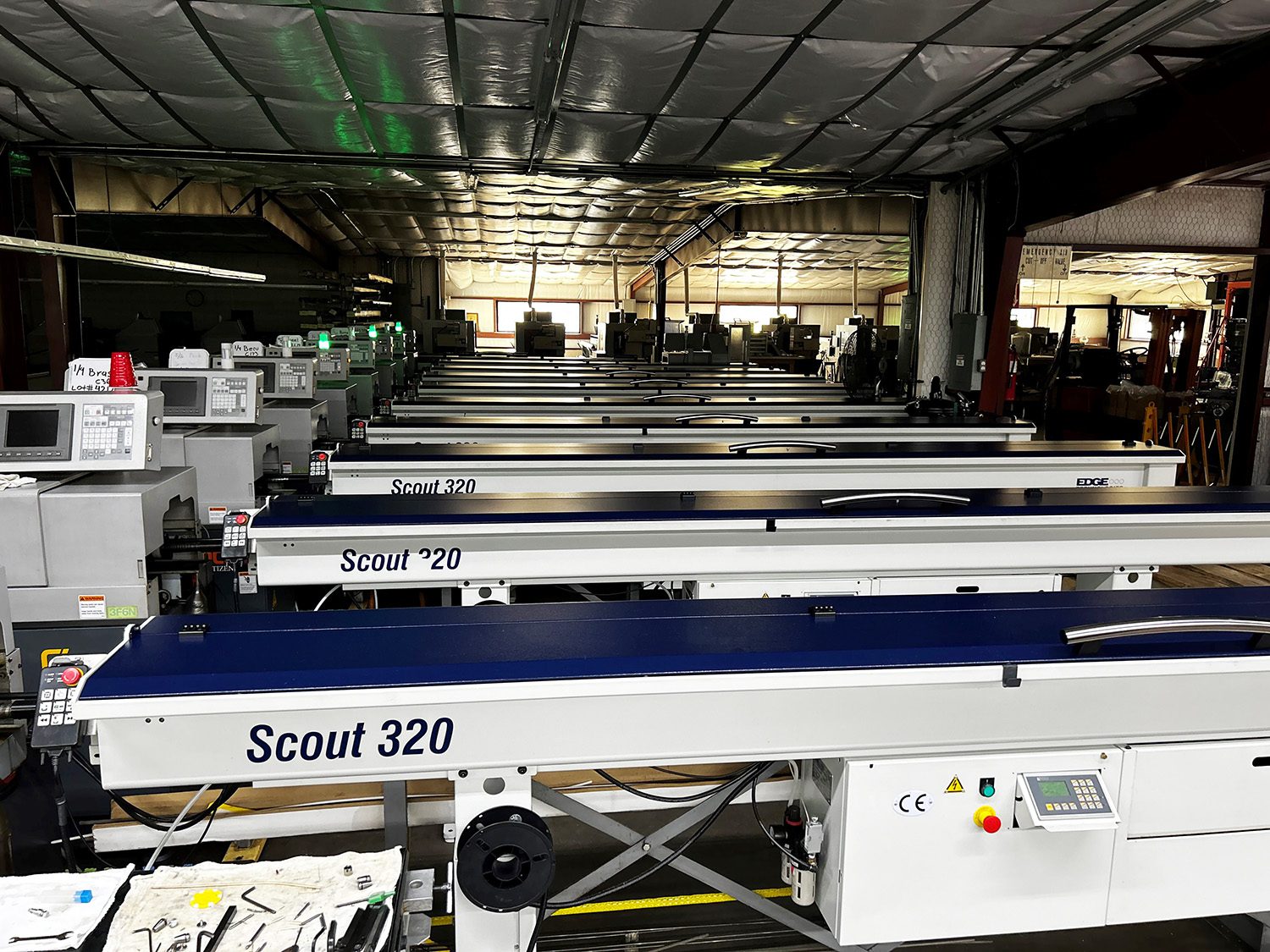 A picture of Scout 320 bar feeders lined up at Kager Industries for their lights out production